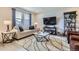 Living room with hardwood floors, a neutral color palette, and comfortable seating at 6621 N Ceylon St, Denver, CO 80249
