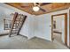 Carpeted living room features wooden staircase, access to other rooms, and ceiling fan at 8186 2Nd Ave, Arvada, CO 80007