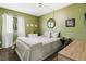 Cozy bedroom with a comfortable bed and soothing green walls at 1900 E 127Th Cir, Thornton, CO 80241