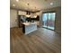 Open concept kitchen with island, stainless steel appliances, and access to backyard at 27472 E 1St Ave, Aurora, CO 80018