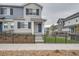 Two-story townhouse with gray and white brick exterior at 27472 E 1St Ave, Aurora, CO 80018