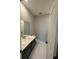 Modern bathroom with hexagon tile flooring, white vanity, and herringbone tile backsplash at 27472 E 1St Ave, Aurora, CO 80018