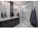 Modern bathroom with double vanity, large shower, and plenty of storage at 5146 N Quemoy Ct, Aurora, CO 80019