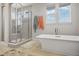 Spa-like bathroom with a walk-in shower, soaking tub and large windows at 25851 E Clifton Pl, Aurora, CO 80016