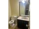 Small bathroom with dark vanity and tiled floor at 1050 S Monaco Pkwy # 23, Denver, CO 80224