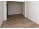 Empty dining room with wood-look flooring and an open floor plan at 6144 E 154Th Pl, Thornton, CO 80602