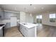 Modern kitchen with gray cabinets, quartz countertops, and island at 6144 E 154Th Pl, Thornton, CO 80602