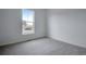 Spacious bedroom with grey carpet and a window offering an outside view at 3452 N Gold Bug Ct, Aurora, CO 80019