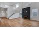 Bright living room featuring hardwood floors, a modern fireplace, and a stunning staircase at 3452 N Gold Bug Ct, Aurora, CO 80019