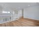 Bright loft area with hardwood floors and white railings overlooking the living area at 3452 N Gold Bug Ct, Aurora, CO 80019