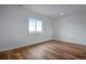 Bright bedroom featuring hardwood floors and a large window at 3452 N Gold Bug Ct, Aurora, CO 80019