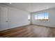 Large bedroom with hardwood floors and a big window with a view at 3452 N Gold Bug Ct, Aurora, CO 80019