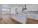 Modern kitchen with white cabinets and island at 3452 N Gold Bug Ct, Aurora, CO 80019
