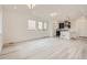 Spacious living room with light grey wood-look floors at 6877 Kendrick Ln, Arvada, CO 80007