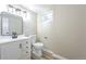 Basement bathroom with white vanity, toilet, and black accents at 2866 E Euclid Pl, Centennial, CO 80121