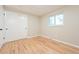 Well-lit bedroom featuring hardwood floors and a double closet at 2866 E Euclid Pl, Centennial, CO 80121