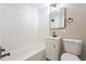 Modern bathroom with white vanity, tub, and black accents at 2866 E Euclid Pl, Centennial, CO 80121