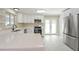 Updated kitchen featuring white cabinets, quartz countertops and island at 2866 E Euclid Pl, Centennial, CO 80121
