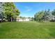 Large backyard with grassy lawn, mature trees, and detached garage at 2866 E Euclid Pl, Centennial, CO 80121