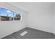 Simple bedroom with gray carpeting and a window at 4463 Adams St, Denver, CO 80216