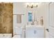 Bathroom with white vanity and tile shower/tub at 6311 W Byers Pl, Lakewood, CO 80226