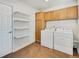 Bright laundry room features washer, dryer, and ample shelving at 6311 W Byers Pl, Lakewood, CO 80226