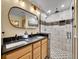 Elegant bathroom with double sinks, a walk-in shower, and modern fixtures at 6765 S Adams Way, Centennial, CO 80122