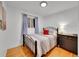 Bright bedroom with hardwood floors and a comfortable bed at 6765 S Adams Way, Centennial, CO 80122