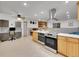 Open kitchen features stainless steel appliances and an island with seating at 6765 S Adams Way, Centennial, CO 80122