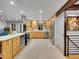 Bright kitchen with light wood cabinets, stainless steel appliances, and a large island at 6765 S Adams Way, Centennial, CO 80122