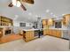 Updated kitchen with wood cabinets, island, and stainless steel appliances at 6765 S Adams Way, Centennial, CO 80122