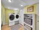 Basement laundry room with washer, dryer, and shelving at 6765 S Adams Way, Centennial, CO 80122