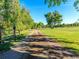 Image of a park path with lush greenery and trees on either side at 6765 S Adams Way, Centennial, CO 80122