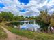 Serene pond surrounded by trees and a walking path at 6765 S Adams Way, Centennial, CO 80122