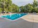 Community swimming pool with lounge chairs and trees at 6765 S Adams Way, Centennial, CO 80122