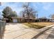 Front view of a Ranch style home with a long driveway and mature trees at 3112 Salem St, Aurora, CO 80011