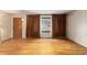 Hardwood floor living room with large windows and brown curtains at 3112 Salem St, Aurora, CO 80011