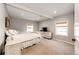 Primary bedroom with a queen-size bed, dresser, and two windows at 1042 Buttercup Rd, Elizabeth, CO 80107