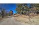 Long driveway leading to the house with wooden fence at 1042 Buttercup Rd, Elizabeth, CO 80107