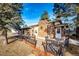 Brick ranch house with stone facade, deck, and mature trees at 1042 Buttercup Rd, Elizabeth, CO 80107