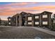 Two-story building with dark brown exterior and stone accents at 875 E 78Th Ave # 67, Denver, CO 80229