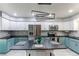Modern kitchen with teal cabinets and a large island at 2790 S Wheeling Way, Aurora, CO 80014
