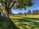 Peaceful view of a golf course with a tree-lined path and homes at 2790 S Wheeling Way, Aurora, CO 80014