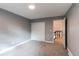 Spacious bedroom with gray walls, carpet, and access to upper level at 2790 S Wheeling Way, Aurora, CO 80014