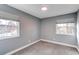 Cozy bedroom with gray walls, neutral carpet, and window coverings at 2790 S Wheeling Way, Aurora, CO 80014