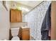 Clean bathroom with a shower/tub combo and wood cabinets at 3728 N Quitman St, Denver, CO 80212