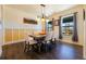 Bright dining room featuring a table with six chairs and hardwood floors at 407 Oxbow Dr, Brighton, CO 80601