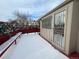 Snowy deck with bench and access to backyard at 11132 E Harvard Dr, Aurora, CO 80014