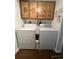Laundry room with washer, dryer, and built-in cabinets at 11132 E Harvard Dr, Aurora, CO 80014