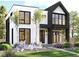 Modern two-story home with black and white exterior, balcony, and landscaped yard at 2892 N Monroe St, Denver, CO 80205